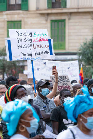 Palma, Majorca, Spain - June 7, 2020: Black people with medical mask and banners during demonstration against racismのeditorial素材
