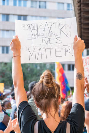 Palma, Majorca, Spain - June 7, 2020: Woman holding a banner during demonstration against racism. Black lives matter message.のeditorial素材