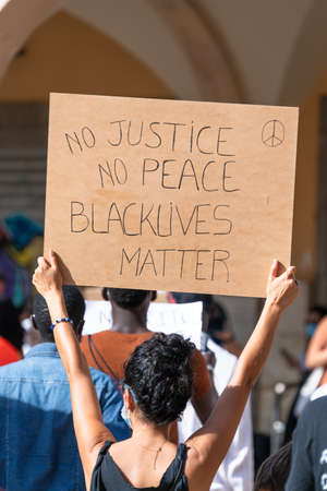 Palma, Majorca, Spain - June 7, 2020: Woman holding a banner during demonstration against racism....