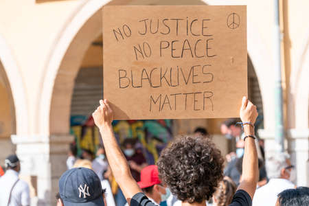 Palma, Majorca, Spain - June 7, 2020: Man holding a banner during demonstration against racism. Black lives matter message.のeditorial素材