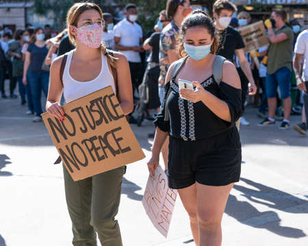 Palma, Majorca, Spain - June 7, 2020: Young white girls, protesters with banners at anti-racism demonstrationのeditorial素材