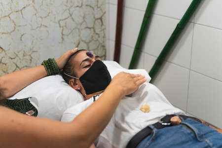 Reiki therapy and chakra alignment to a young girl, using energy stones. Unlocking the heart chakra or Anahataの写真素材