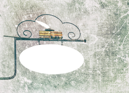 Wrought iron sign with white copy space and white feather pen on a bunch of books, textured in color tones with scratches and stains.の写真素材