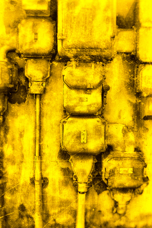 Old electrical cabinet textured in yellow.の写真素材