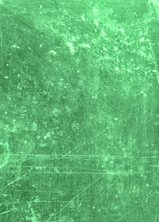 Abstract background textured in minty green tones with scratches and stains.の写真素材