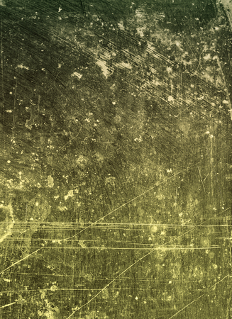 Abstract background textured in a moss green tone with scratches and stains.の写真素材