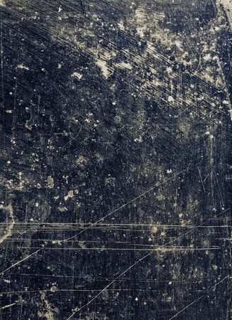 Abstract strong dark blue background textured in different tones with scratches and stains.の写真素材