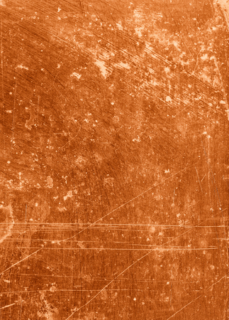 Abstract background textured in rusty orange tones with scratches and stains.の写真素材