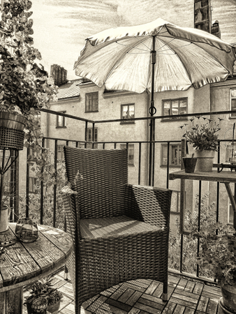 Artistic textured image in sepia tones of a cozy decorated summer balcony in the city.の写真素材
