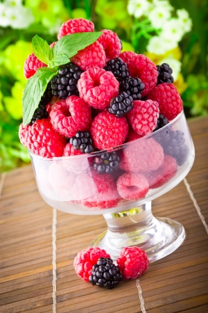 Sweet fresh fruits in glass goblet with mint leafの写真素材