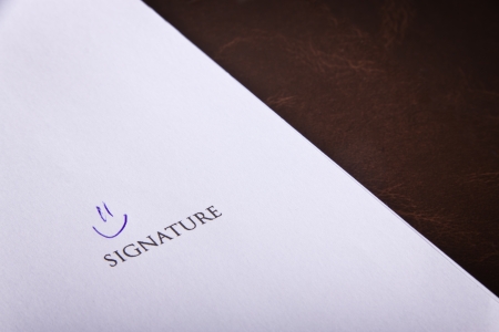 Humorous signature on a documentの写真素材