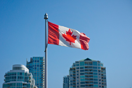Canadian flag on the Vancouver skyscrapers backgroundの写真素材