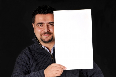 Young man holding blank sign  All on black background の写真素材