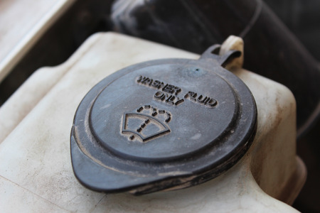 The lid of the washer fluid reservoir from the engine of a carの写真素材