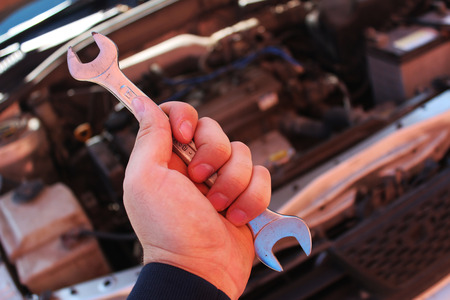 Wrench in the hand of auto mechanicの写真素材