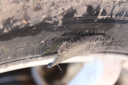 Torn piece of rubber automotive wheelの写真素材