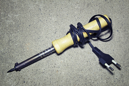Soldering iron on a gray backgroundの写真素材