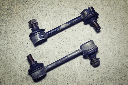 Old worn links stabilizer on a gray background