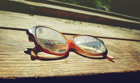 Old glasses on a wooden background