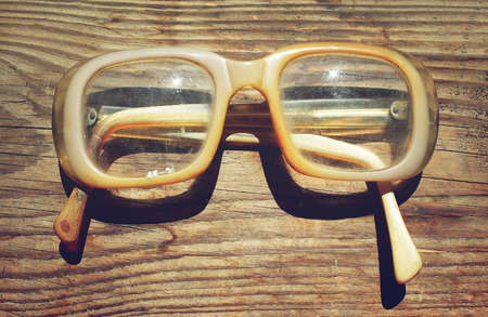 Old glasses on a wooden backgroundの写真素材