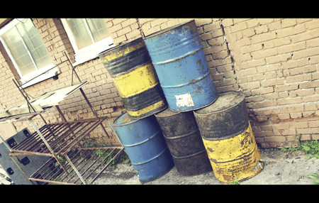 Old dirty barrels of oil under in the industrial zoneの写真素材