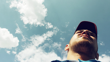 The man on the sky background - view from belowの写真素材
