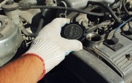The cover oil filler neck of the car in a hand