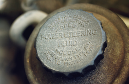 Old worn cap of power steering reservoir