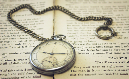 Old pocket watch on the book