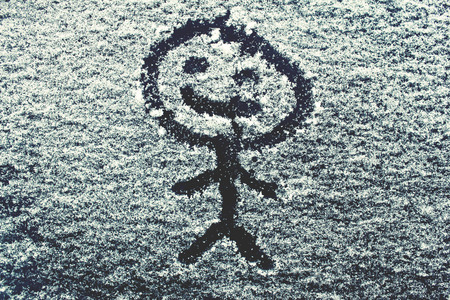 Smile on the snowy car windowの写真素材