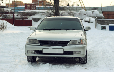 An old car in an industrial area in the winterの写真素材