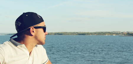 The man in a cap looks at seaの写真素材
