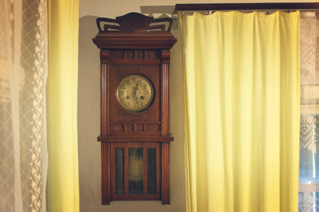 The vintage brown wooden wall worn clockの写真素材