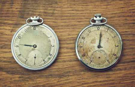 Vintage pocket watch on a wooden backgroundの写真素材