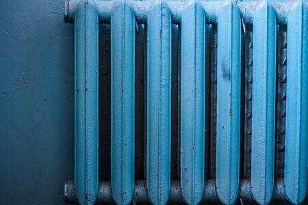 Old shabby radiator of blue color