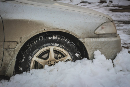 Old dirty car in a snowdriftの写真素材