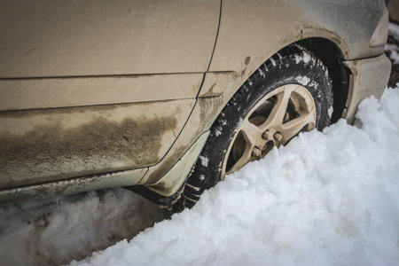 Old dirty car in a snowdriftの写真素材