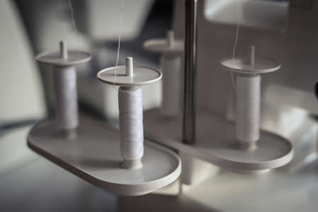 White threads on an overlock sewing machineの写真素材