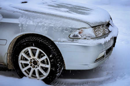 Car in the snow in winterの写真素材