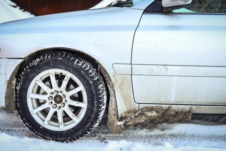 Ice on the bottom of the car after a snowy roadの写真素材