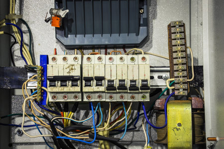 Cable chaos in electric control panel close-up. tangled wires. circuit breakersの写真素材