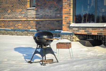 Barbecue and old brazier on the street in winter near the house. Outdoorsの写真素材