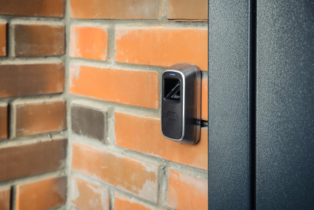 Device for scanning fingerprint. Residential building entrance. brick wallの写真素材