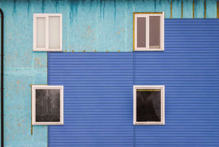 Wall covering of the old house with panels of vinyl siding. Construction and facade reconstruction. Repair of the houseの写真素材