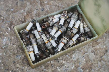 Box with old used car spark plugs close-up. automotive backgroundの写真素材