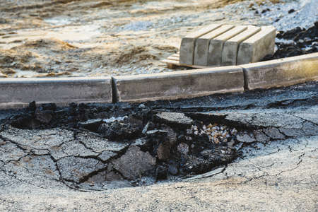 Asphalt swelling close-up. Pothole and pit on roadの写真素材