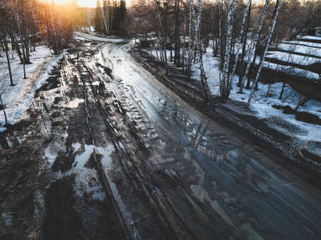 Broken old asphalt road outside the city. Pits and potholes. Aerial viewの写真素材