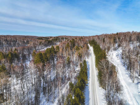 Road in the winter forest. Aerial viewの写真素材
