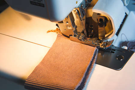 Sewing process on an overlock machine - macro shot. selective focusの写真素材