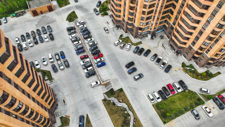 Parking in the courtyard of high-rise buildings in summer. air view